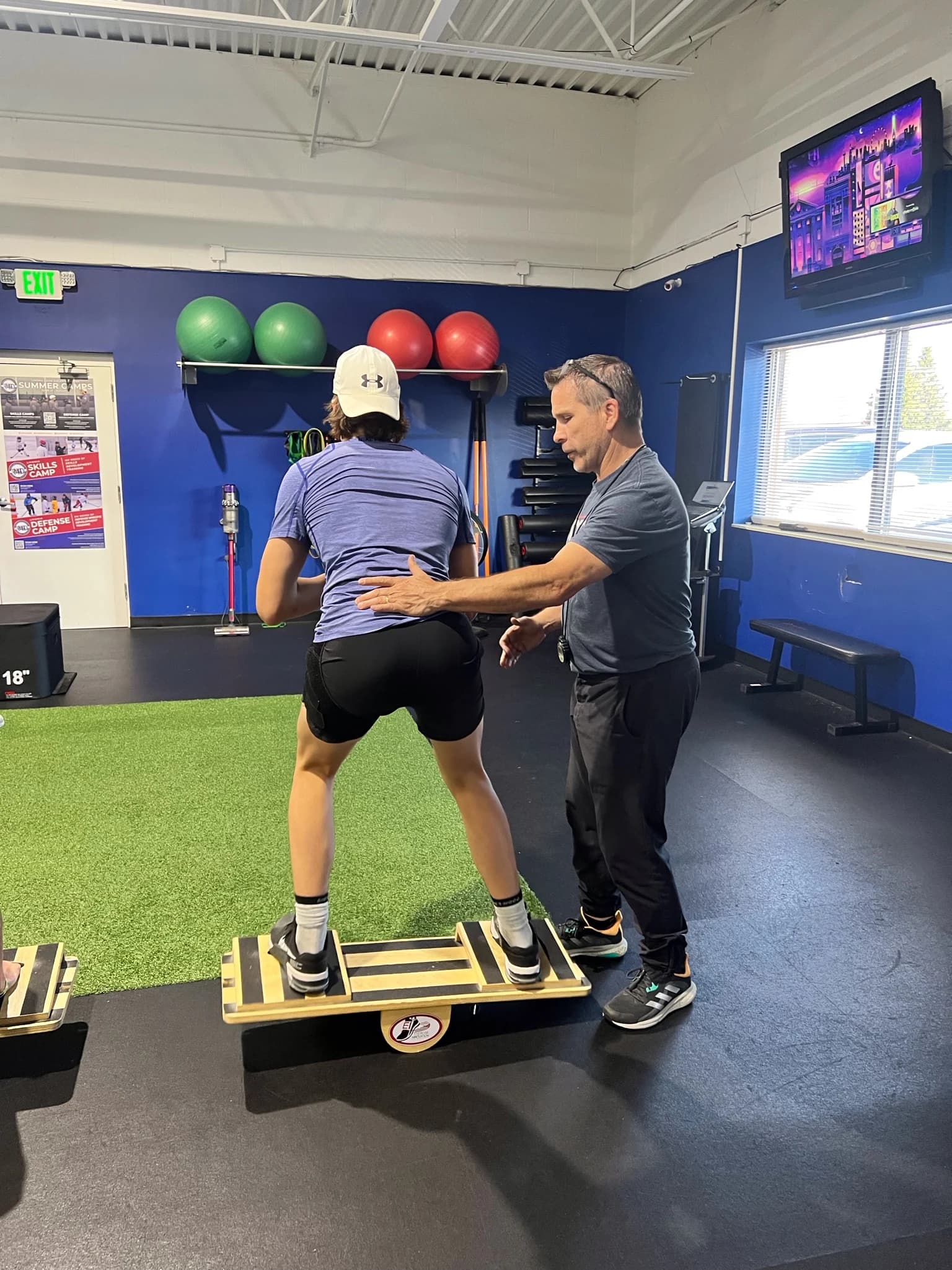 Dave Boyer coaching an athlete on a turf